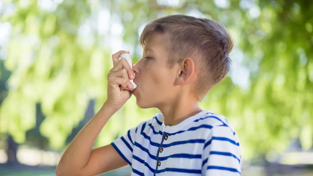 Boy Uses Inhaler In The Park