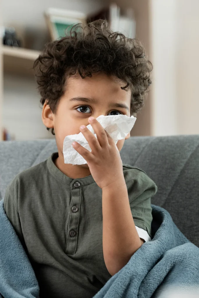 Boy Wiping His Nose With A Tissue