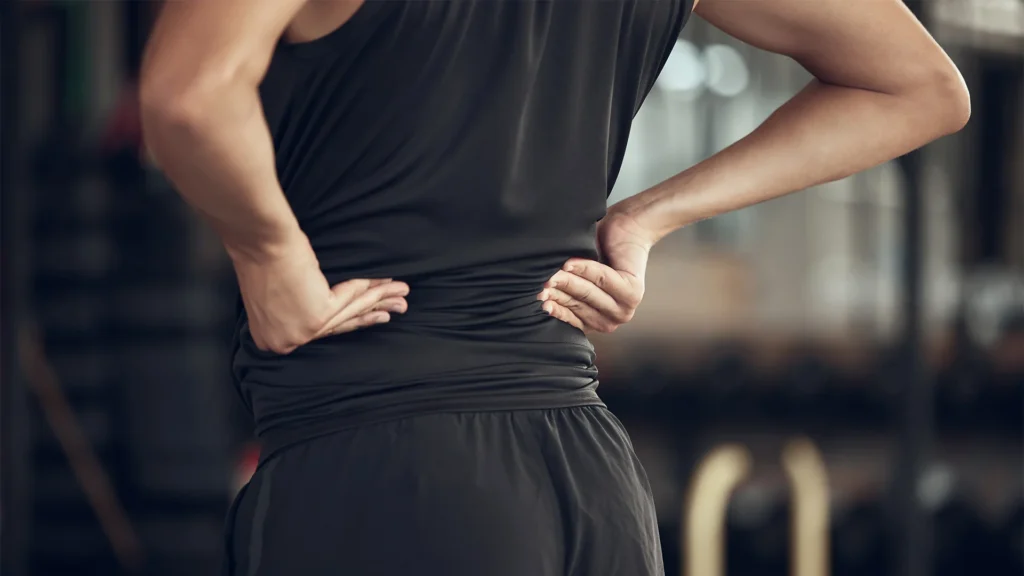 Gym Athlete Holding Lower Back In Pain
