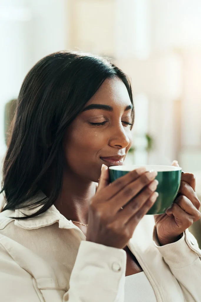 Woman Peacefully Holds A Cup Of Coffee